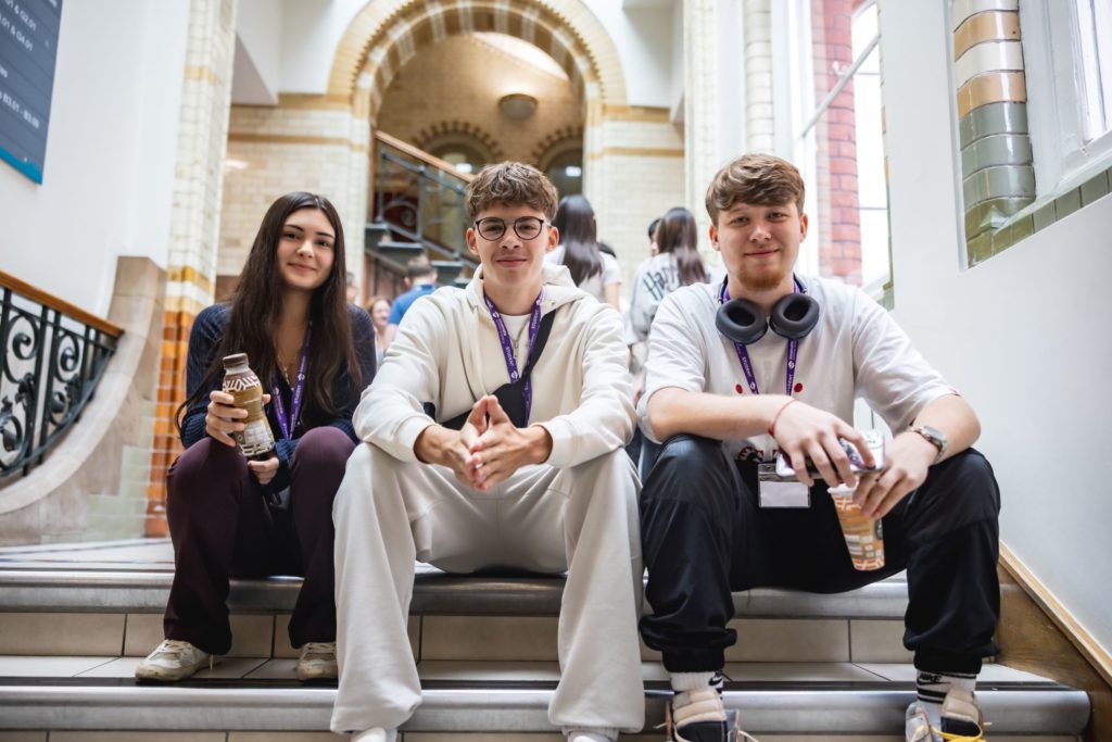 Innovate students sitting on the stairs at UCL